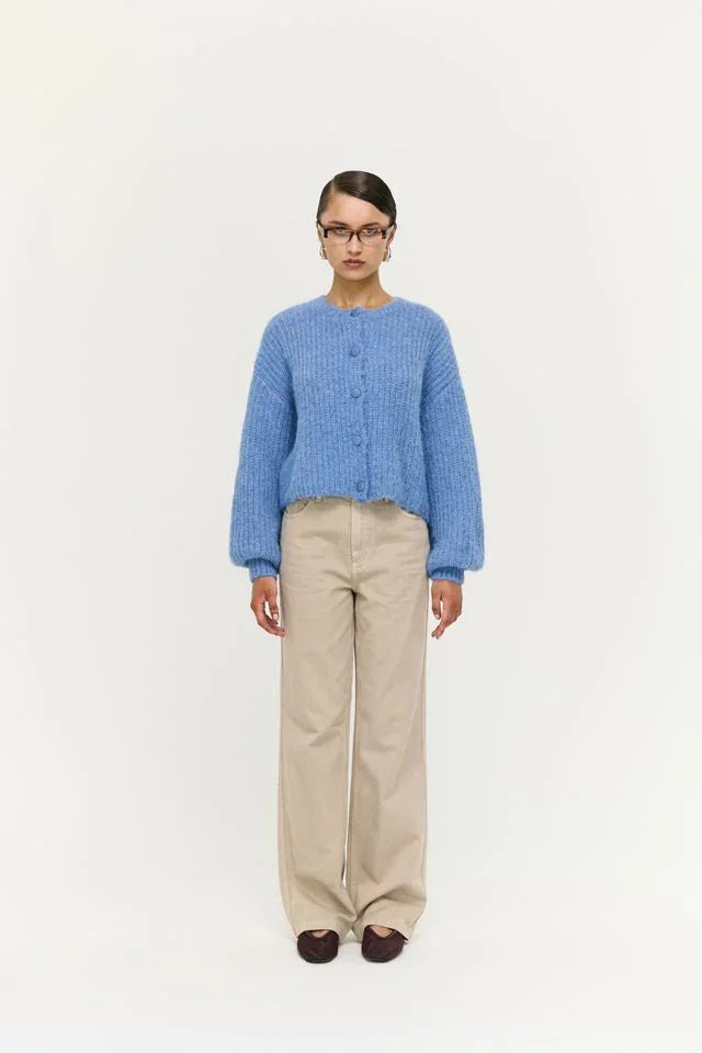 Blue knit cardigan with buttons, beige wide-leg pants, and brown loafers for women's fashion