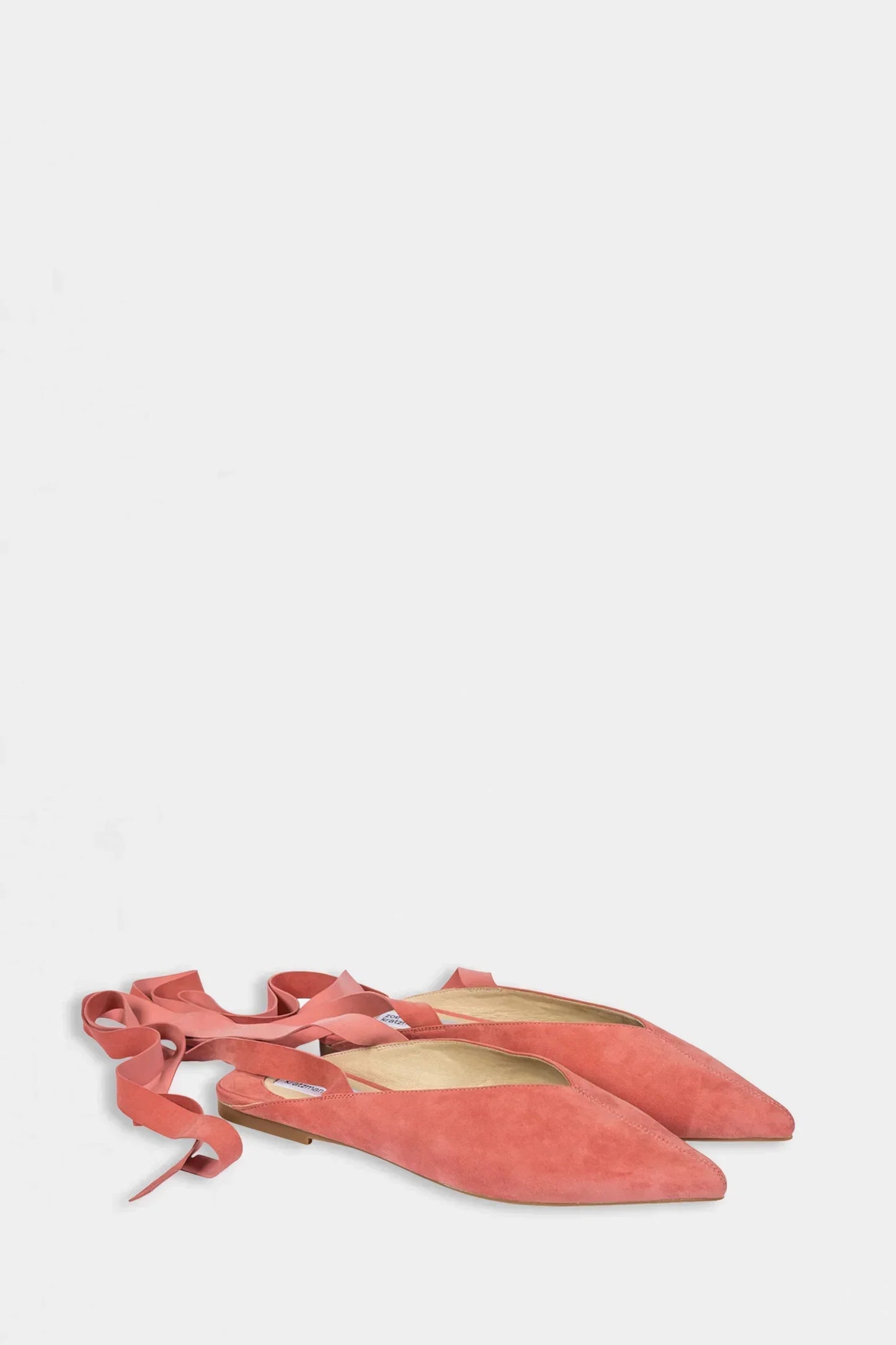Coral pink suede pointed-toe ballet flats with tie ankle straps