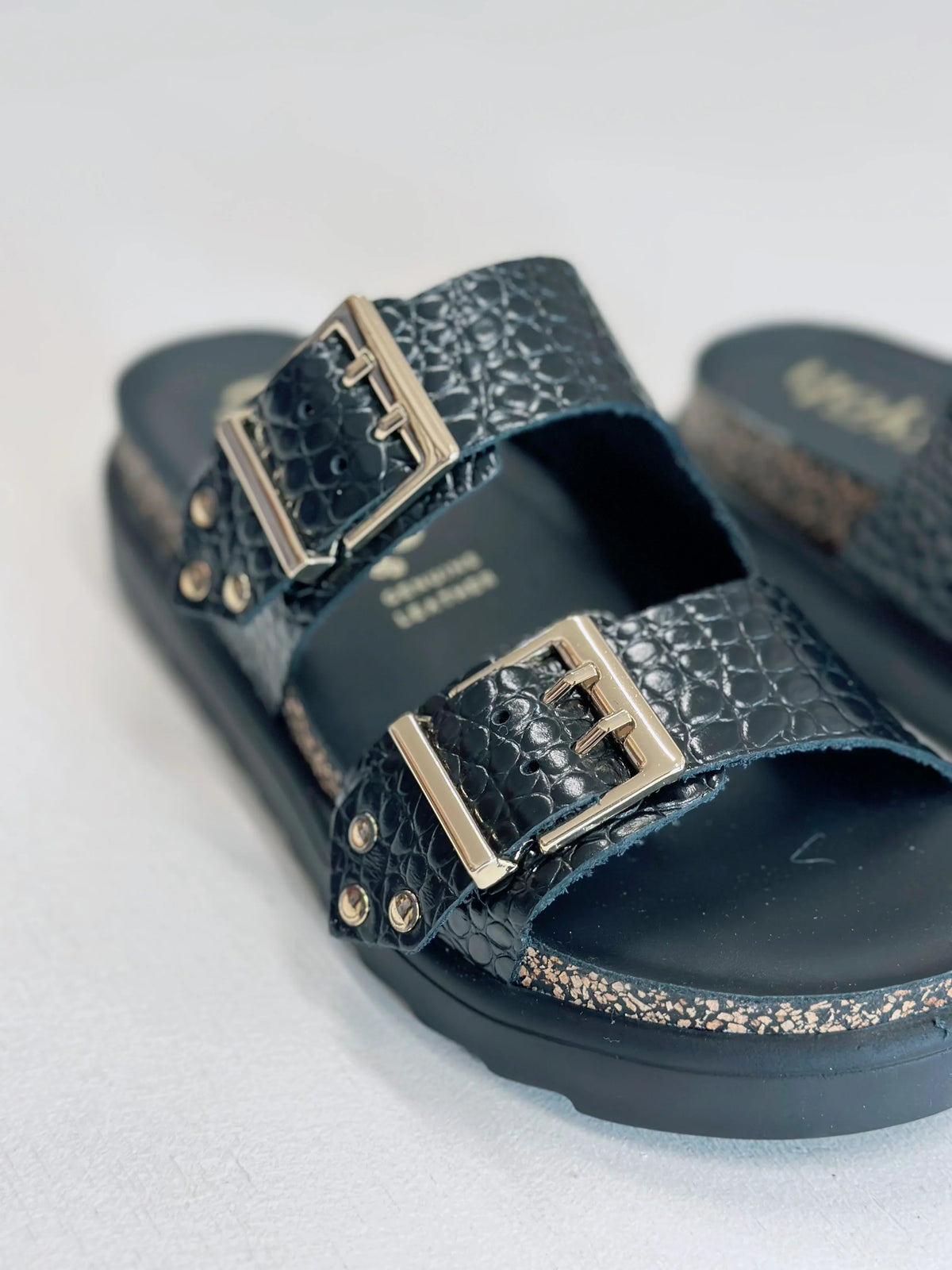 Close-up of YOKONO Tunez 262 platform sandals in black croc embossed leather with gold buckles.