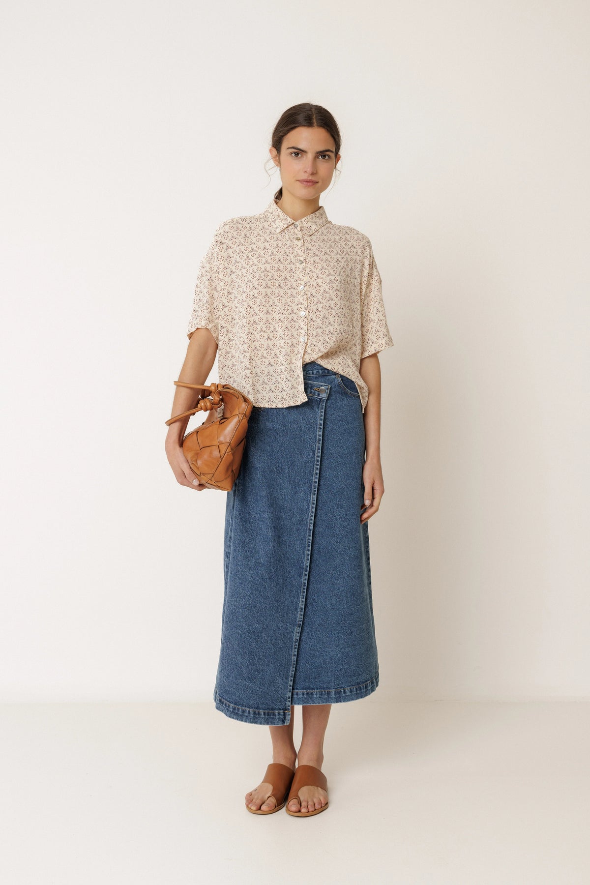 Woman wearing an INDI & COLD Oversized Block Print Shirt in Crudo and a denim midi skirt.