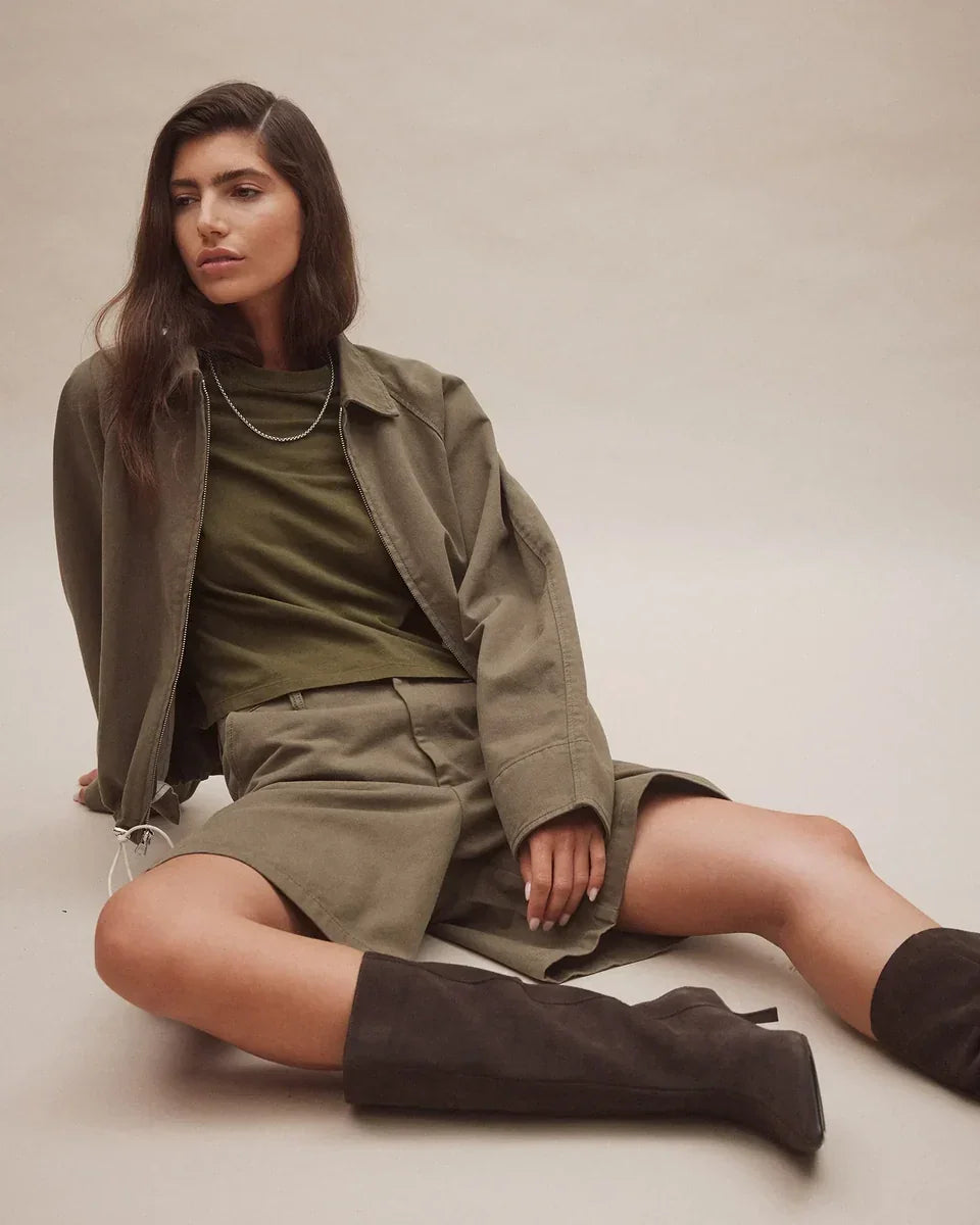 Woman wearing Nobody Denim Jean Tee in Olive with a matching jacket and shorts.