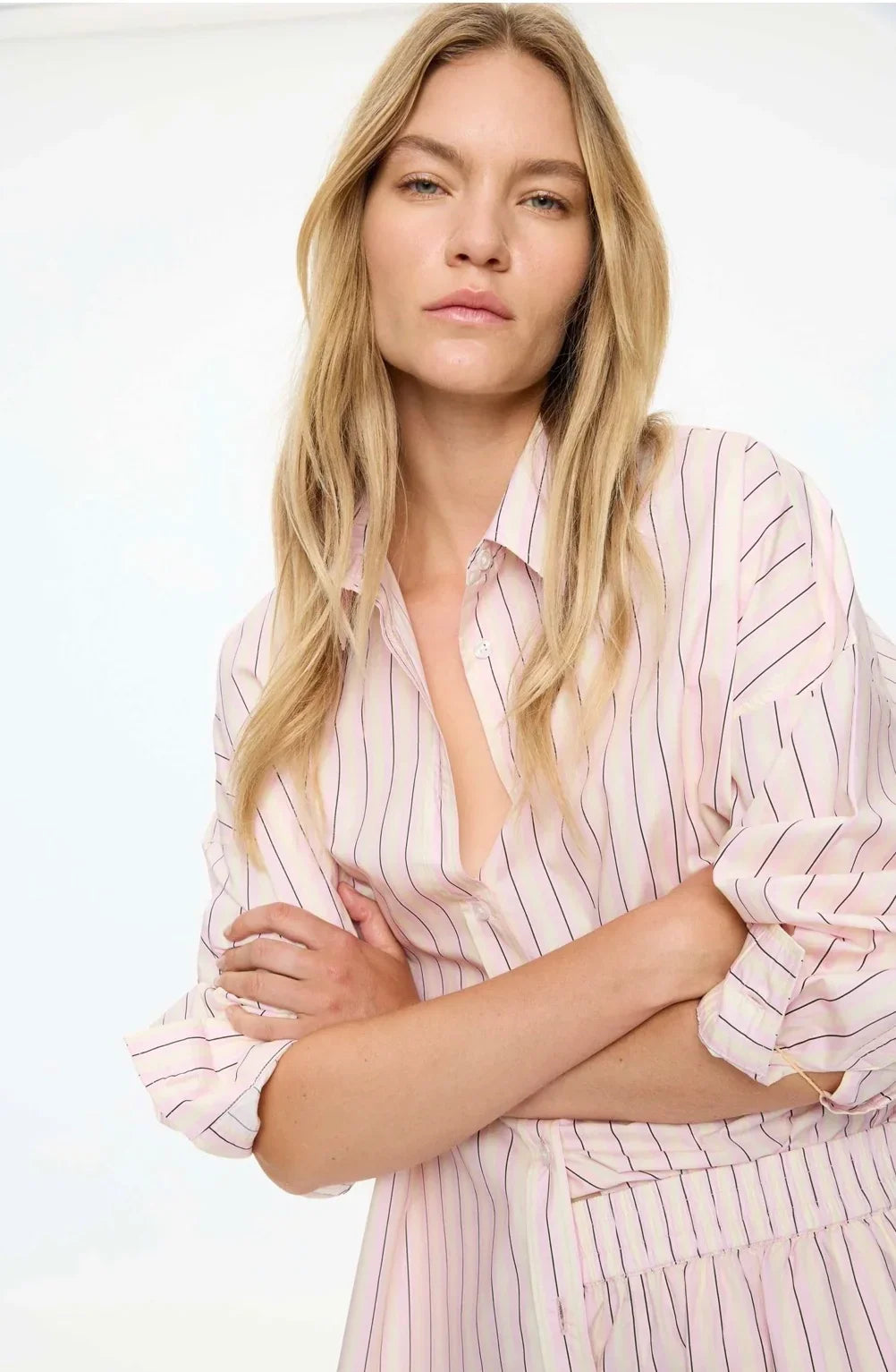 Model wearing the LMND Mara Long Sleeve Shirt in Candy Floss with pink stripes.