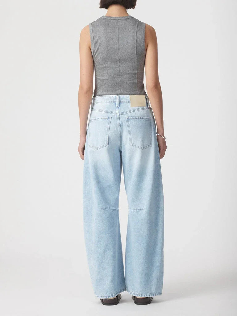 Light blue wide-leg jeans with back pockets, paired with a gray sleeveless top