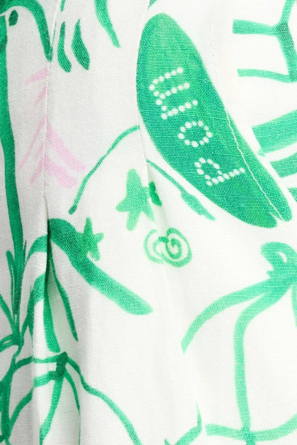 White fabric with green botanical print, featuring leaves and vines for effortless everyday fashion.