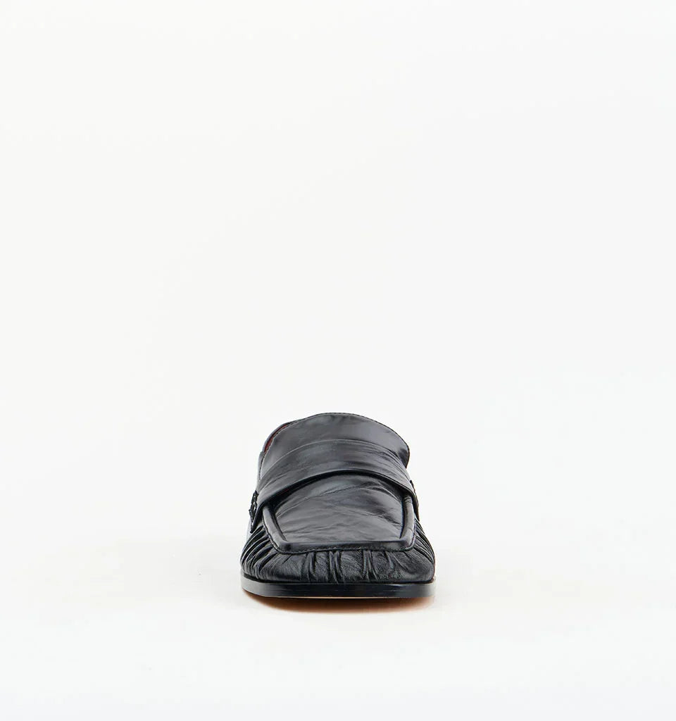Black leather women's loafer with ruched detailing, front view on white background