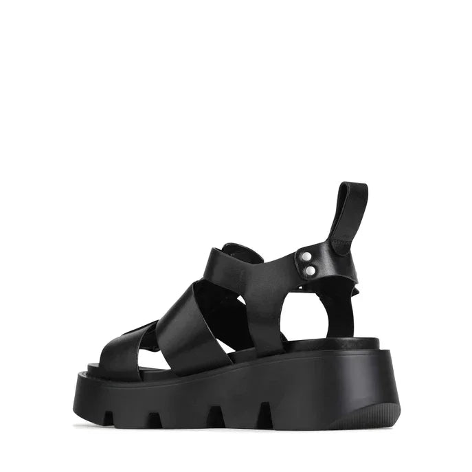 Black platform sandals with crisscross straps and chunky sole for edgy women's fashion