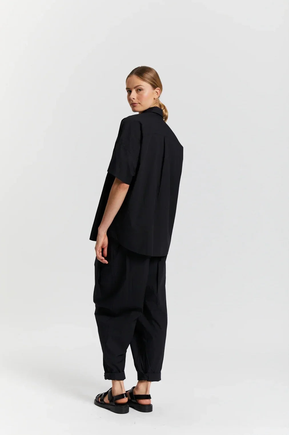 Woman modeling black short sleeve shirt and pants, The Tartan Fox boutique fashion