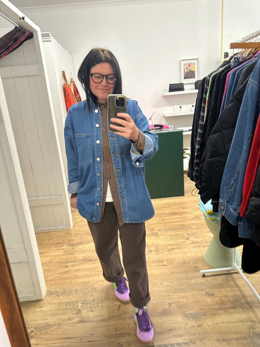 Angela wearing chocolate brown shirt and pants with purple shoes and denim jacket