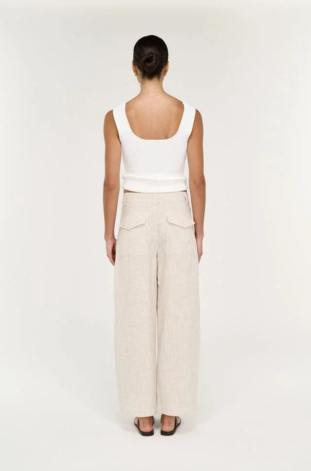 Back view of a woman wearing STAPLE THE LABEL Neve Linen Barrel Leg Pants in oatmeal.