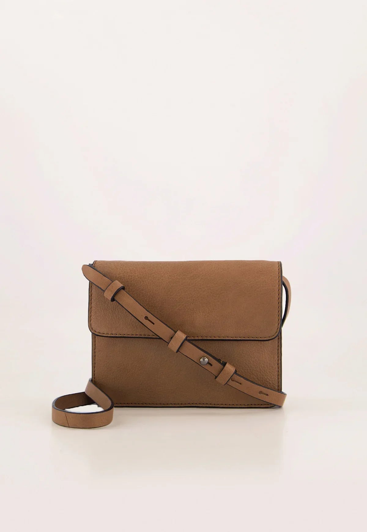 Tan leather crossbody bag with adjustable strap on white background