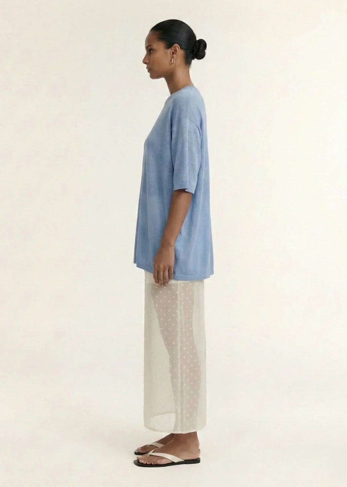 Woman wearing STAPLE THE LABEL Orla Oversized Knit Tee in Dusty Blue with a sheer skirt.