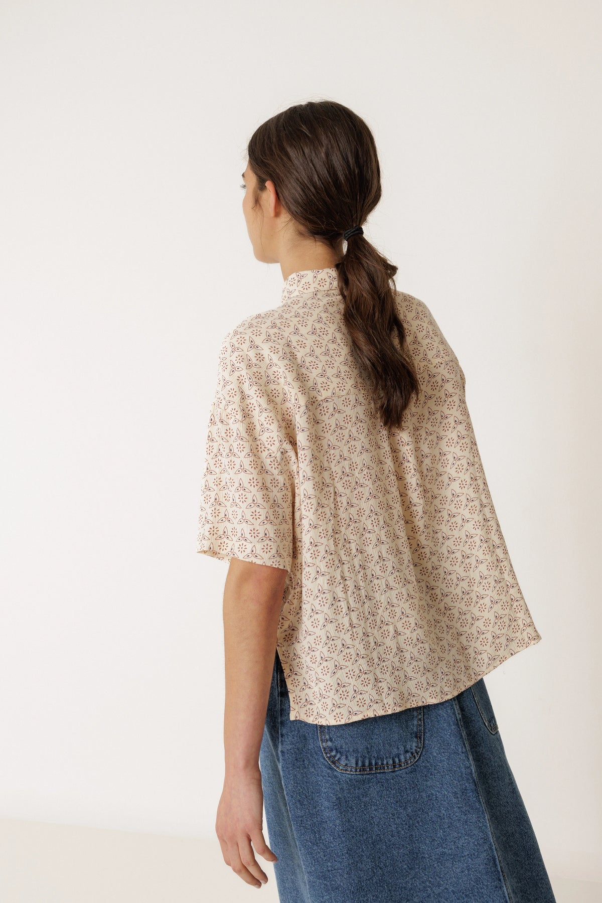 Back view of a woman wearing an INDI & COLD Oversized Block Print Shirt in Crudo.