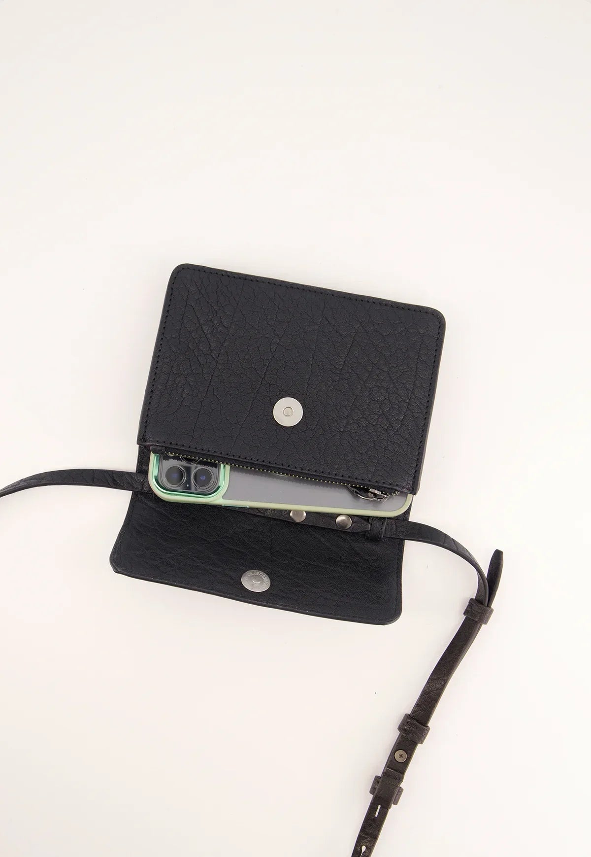Black textured leather crossbody wallet with phone inside, open on white background
