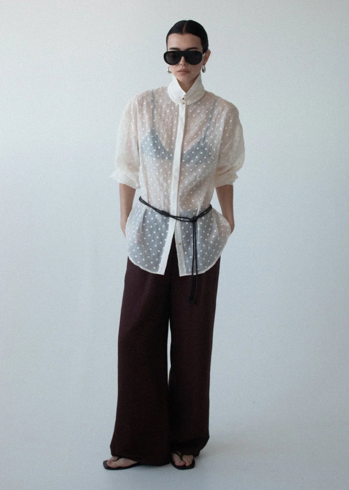 Model wearing Staple the Label Etoile Oversized Shirt in Cream Spot with brown wide-leg trousers.