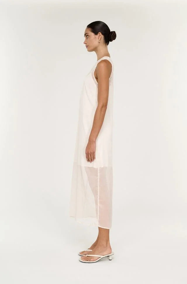 Side view of a woman wearing the STAPLE THE LABEL Aria Sheer Layered Midi Dress in Cream.