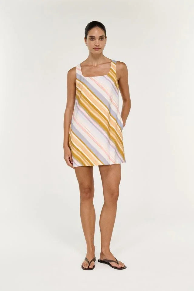 Woman wearing STAPLE THE LABEL Veda Mini Dress in multi-colored diagonal stripes.