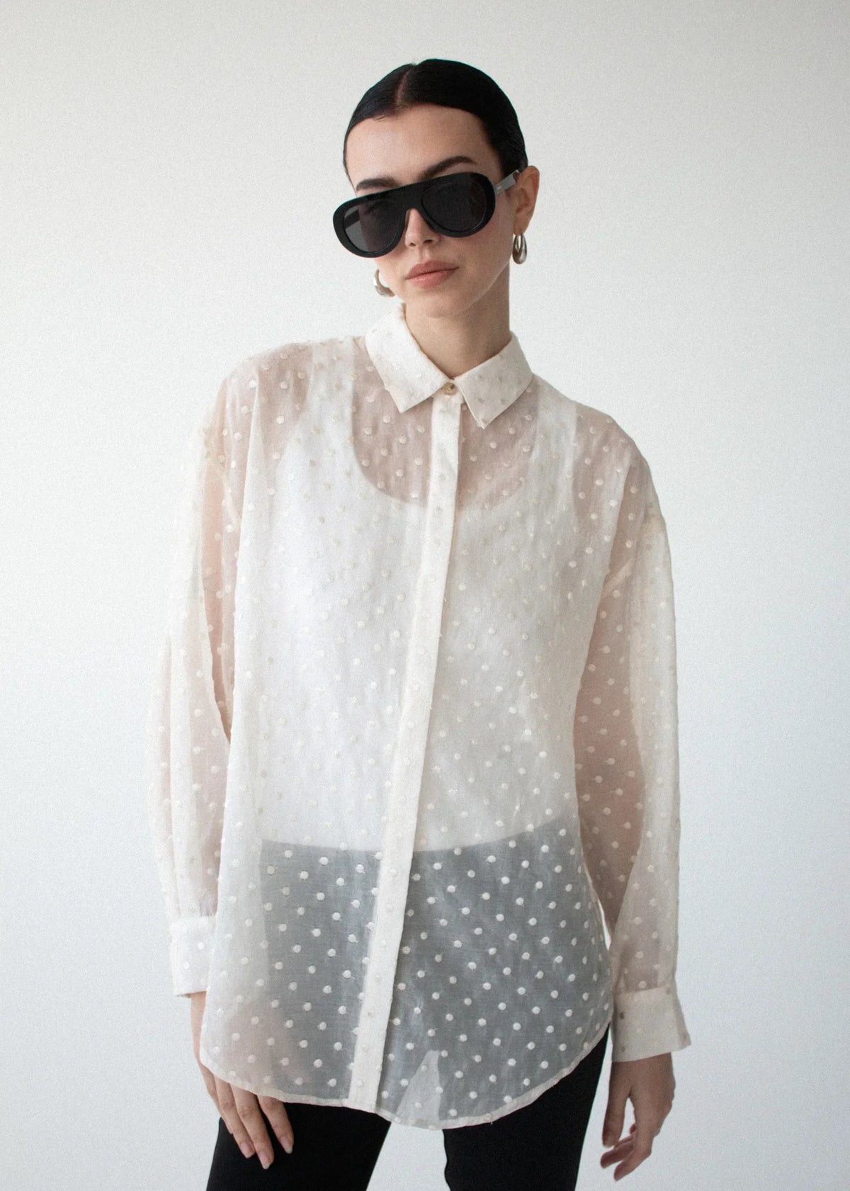 Woman wearing STAPLE THE LABEL Etoile Oversized Shirt in Cream Spot and black sunglasses.