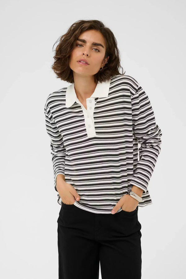Black and white striped long-sleeve polo shirt with white collar, paired with black pants