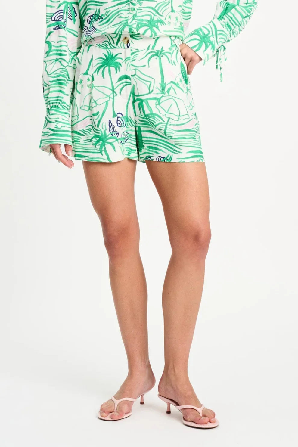 Tropical palm print shorts with matching top, styled with pink heeled sandals for summer fashion