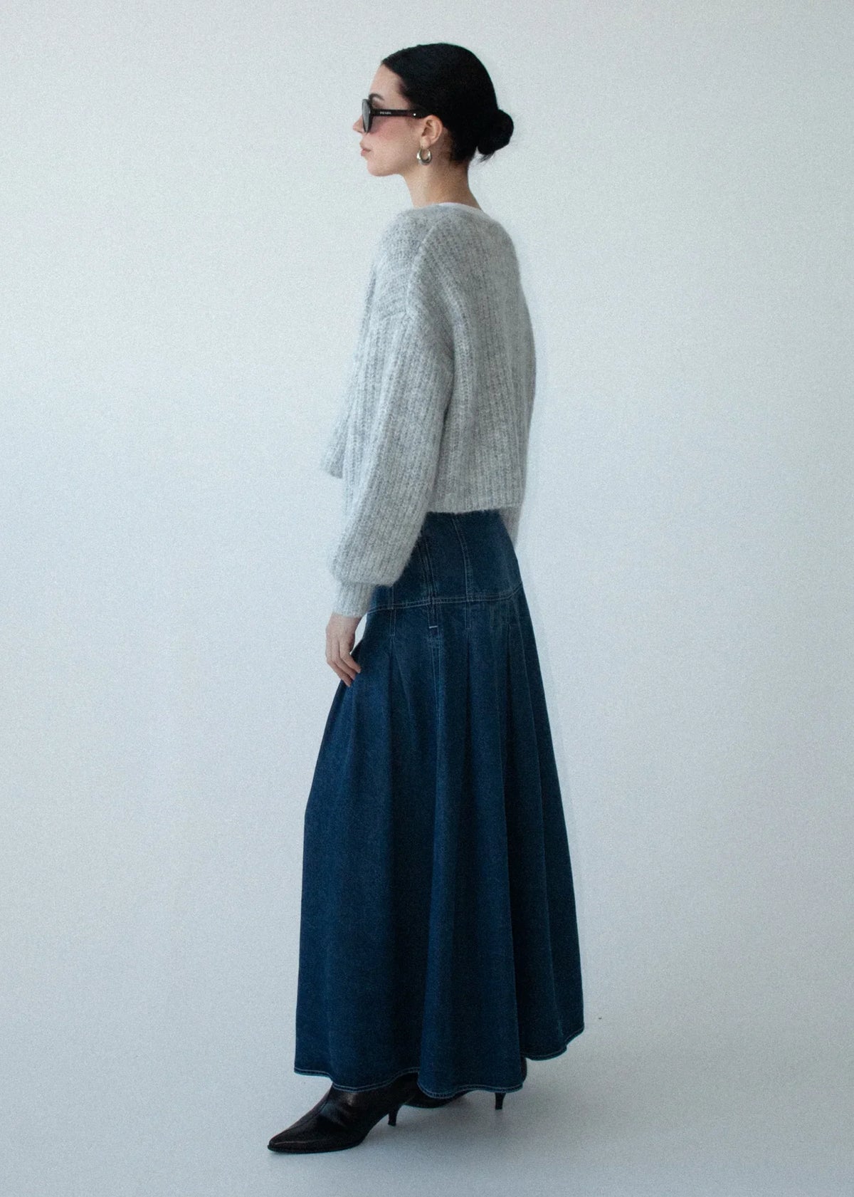 Woman wearing STAPLE THE LABEL Roma Chambray Midi Skirt and a grey knit sweater.