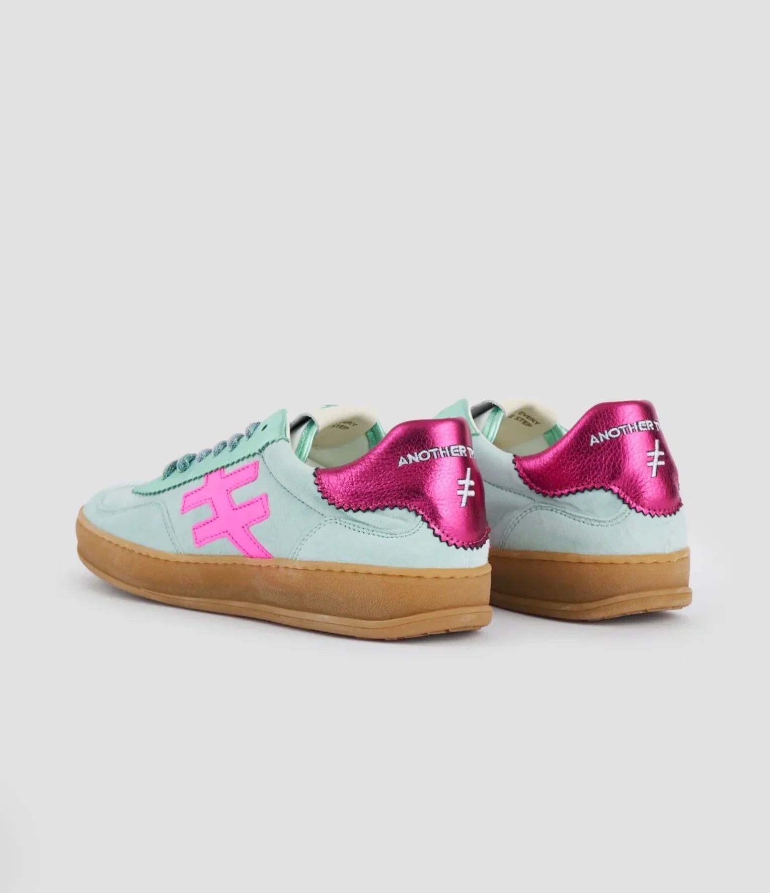 Pair of mint green Another Trend Ivonic II sneakers with metallic pink accents and a gum sole.