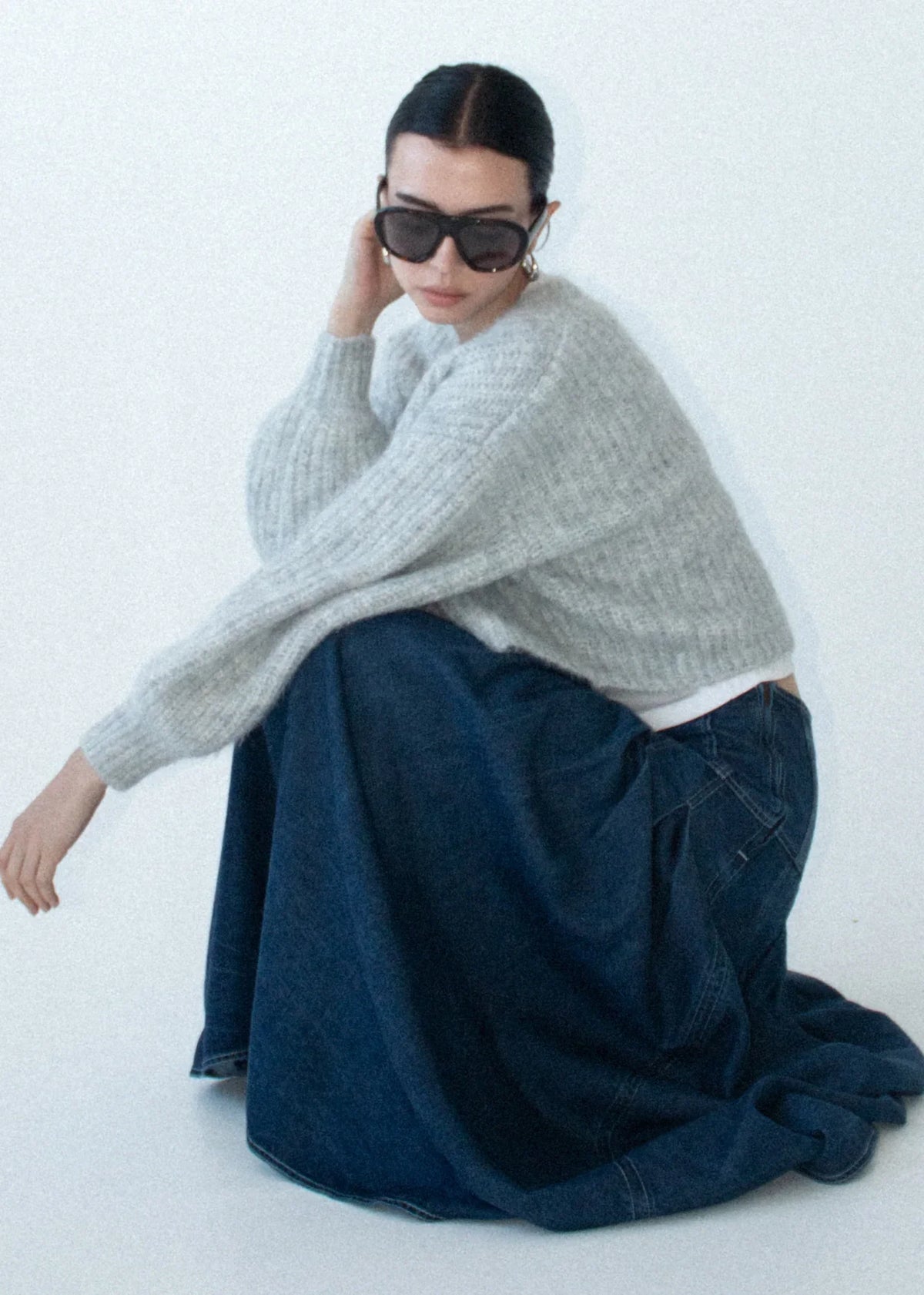 Woman wearing STAPLE THE LABEL Roma Chambray Midi Skirt and a grey oversized knit sweater.