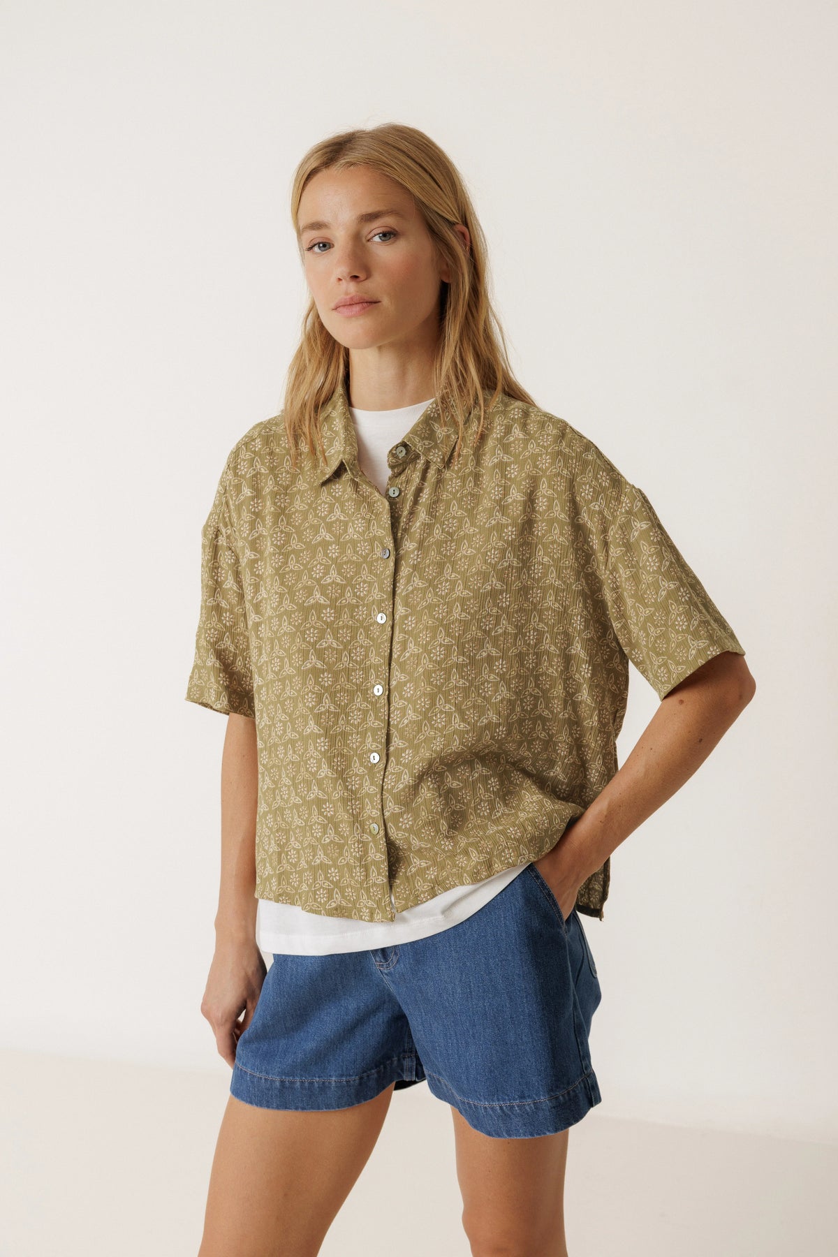 Woman wearing an INDI & COLD Oversized Block Print Short Sleeve Shirt and denim shorts.