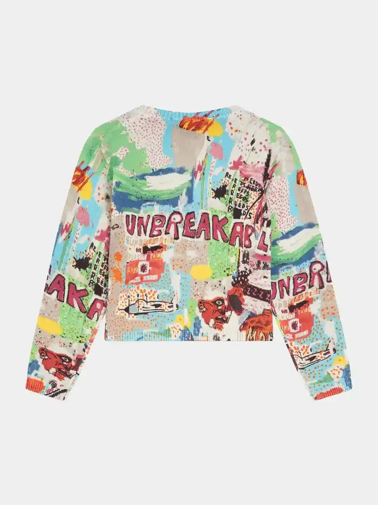 Colorful women's knit sweater with abstract patterns and 'UNBREAKABLE' text on the back.