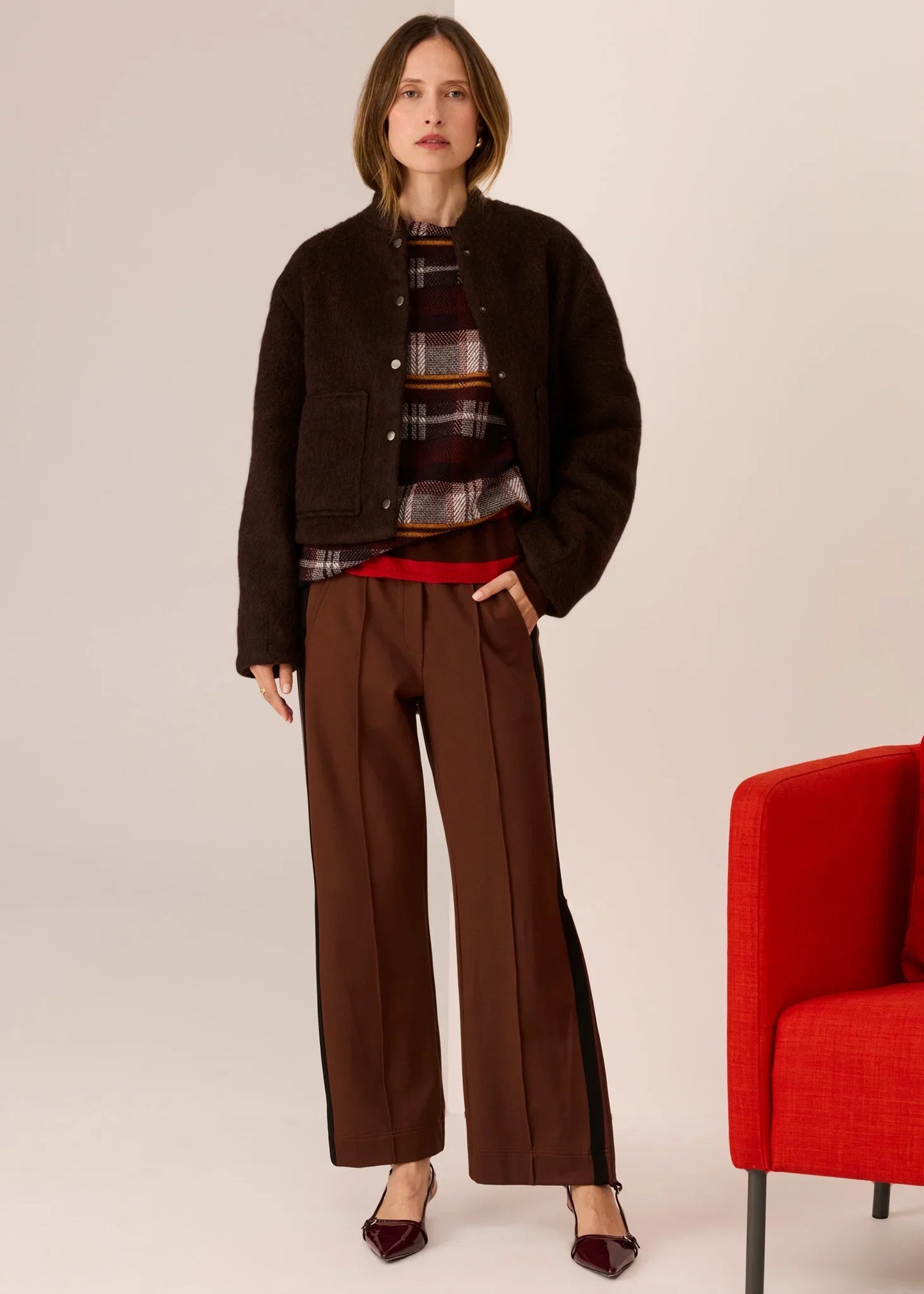 Brown plaid top with cozy jacket, wide-leg pants, and burgundy heels for stylish women's fashion