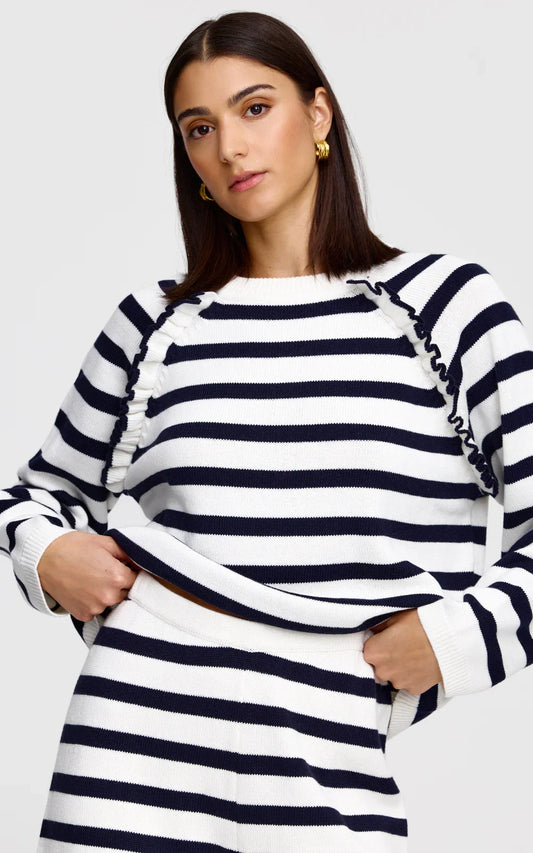 Navy and white striped sweater with ruffled shoulders, paired with matching skirt for women's fashion