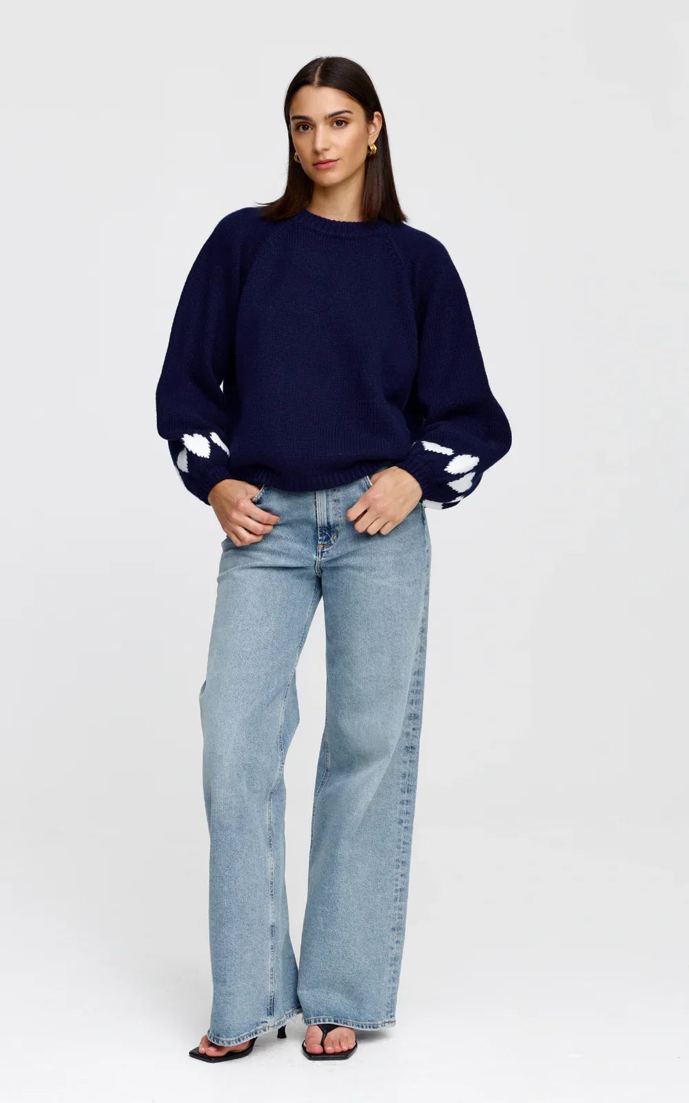 Cherie Hearts Knit Sweate knit sweater with white  heart cuffs paired with light wash wide-leg jeans