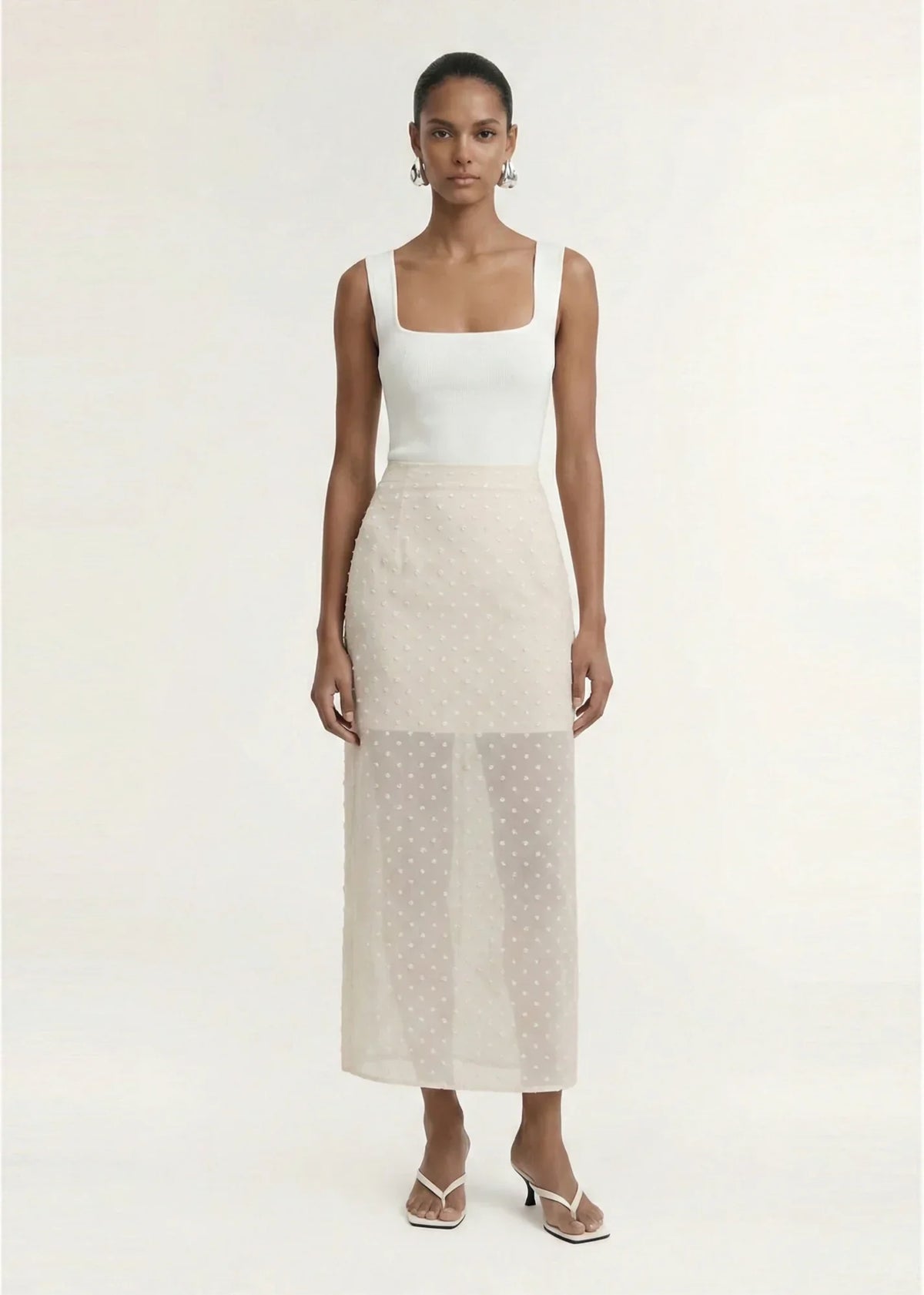 Model wearing STAPLE THE LABEL Etoile Layered Midi Skirt in Cream Spot and a white tank top.