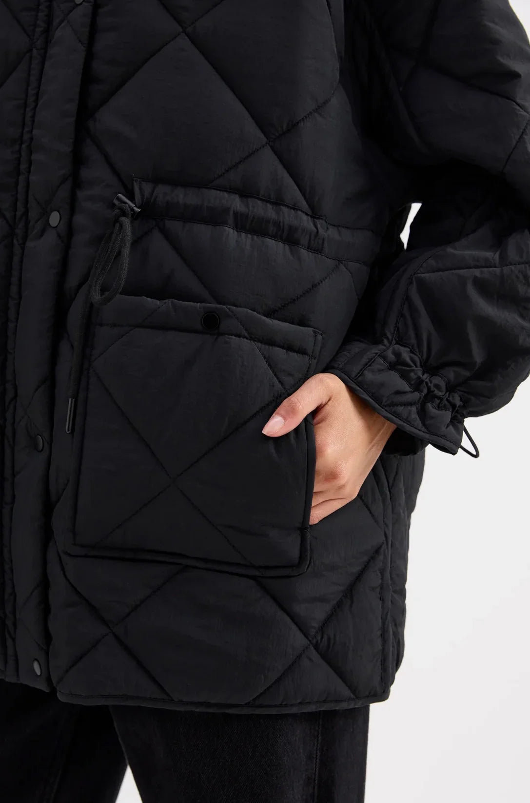 Black quilted puffer jacket with diamond stitching and front pocket, women's winter outerwear