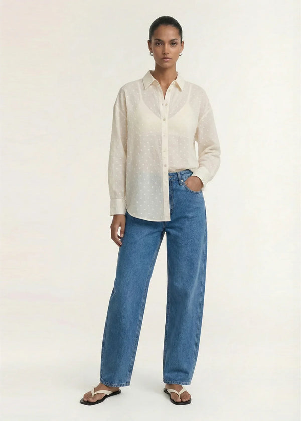 Woman wearing STAPLE THE LABEL Etoile Oversized Shirt in Cream Spot with wide-leg blue jeans