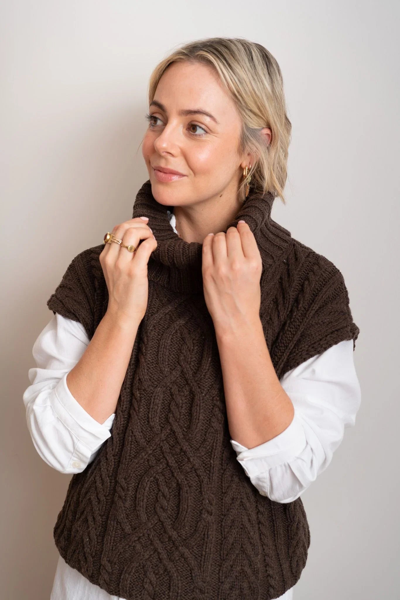 Brown cable knit vest over white shirt, cozy women's fashion