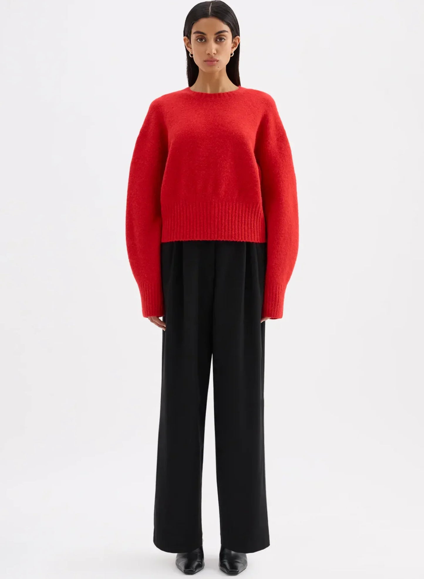 Woman in a cropped red jumper