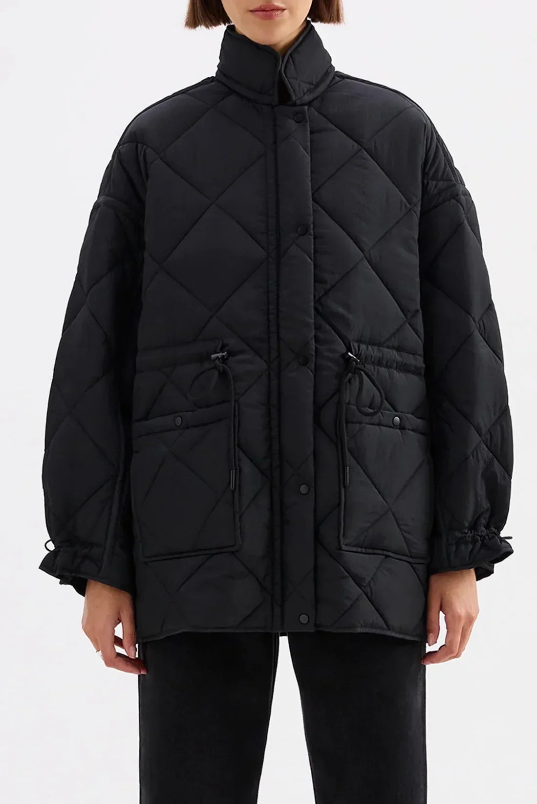 Black quilted puffer coat with drawstring pockets and button front, women's winter fashion