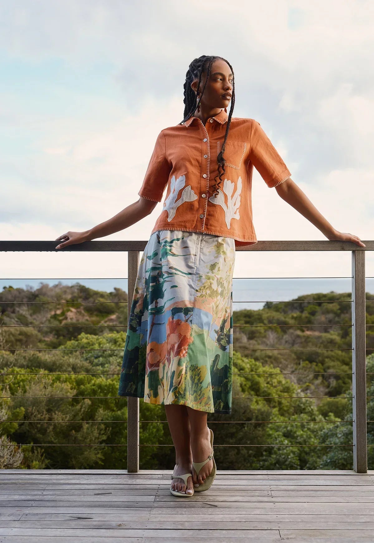 Woman wearing NANCYBIRD Summer Shirt in Blossom Appliqué and a printed midi skirt.