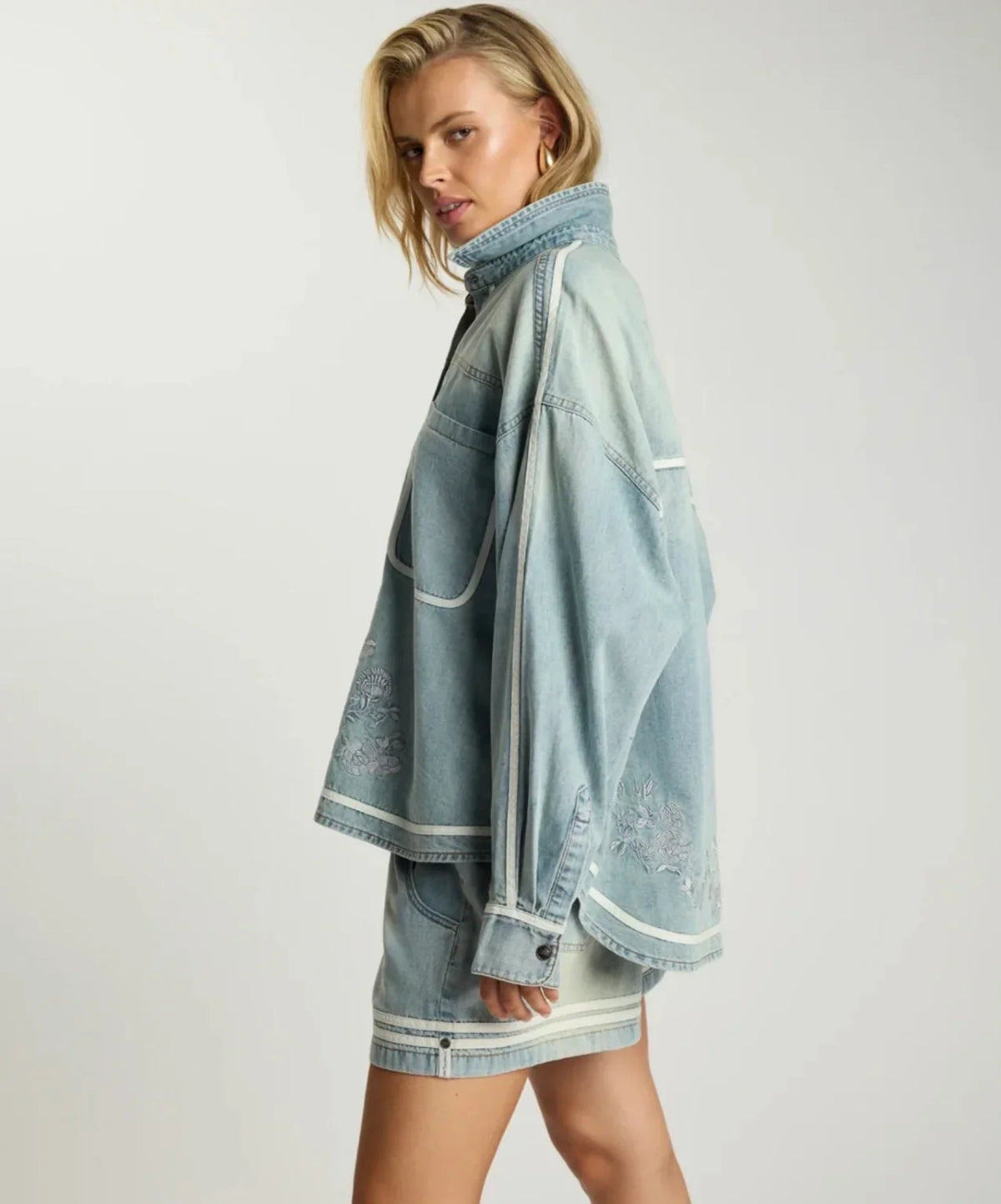 Woman wearing a ONE TEASPOON Folklore Embroidered Shirt and matching denim shorts.
