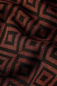 Textured fabric with a brown and black geometric diamond pattern, soft material close-up