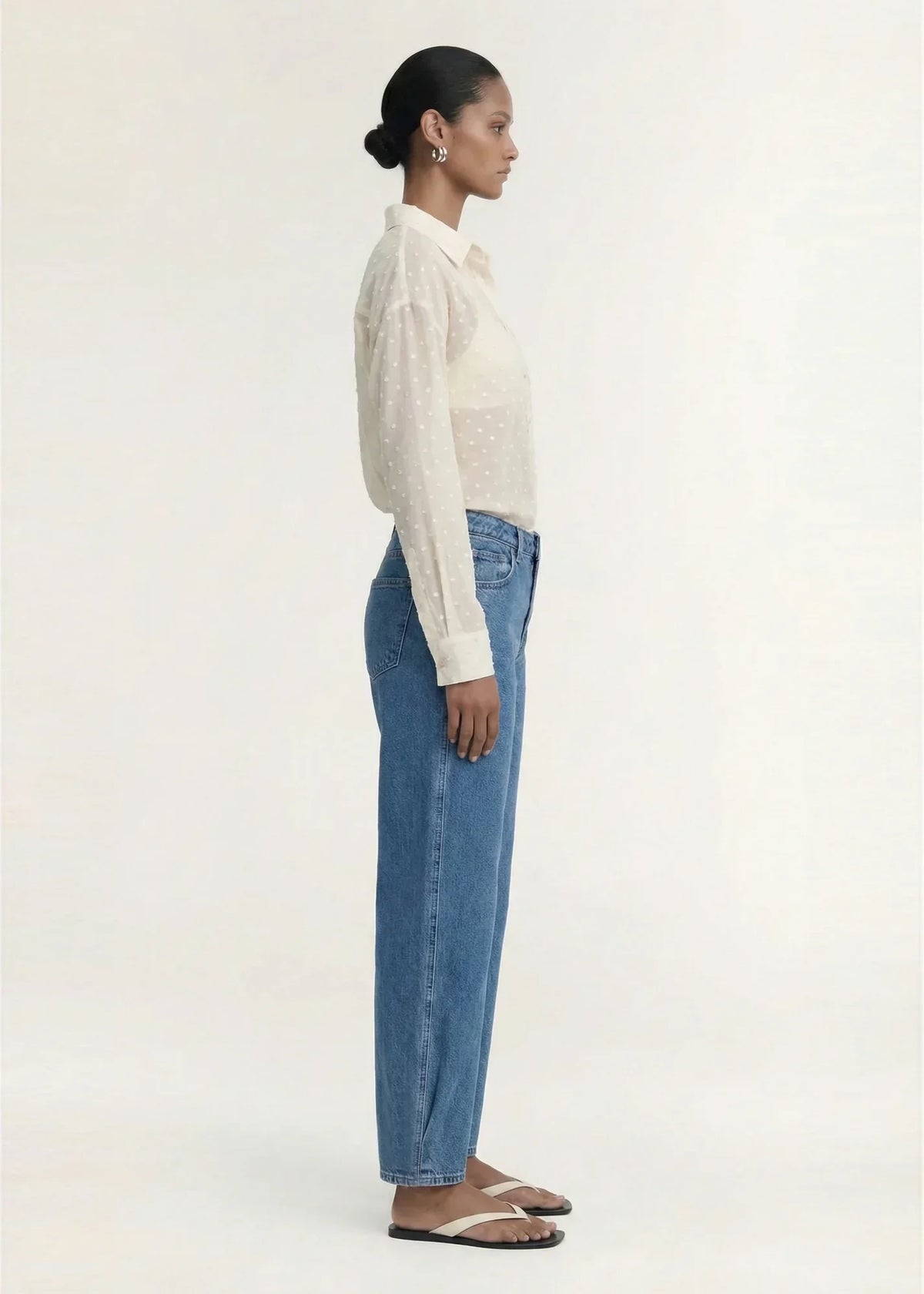 Woman wearing STAPLE THE LABEL Etoile Oversized Shirt in Cream Spot and blue jeans.