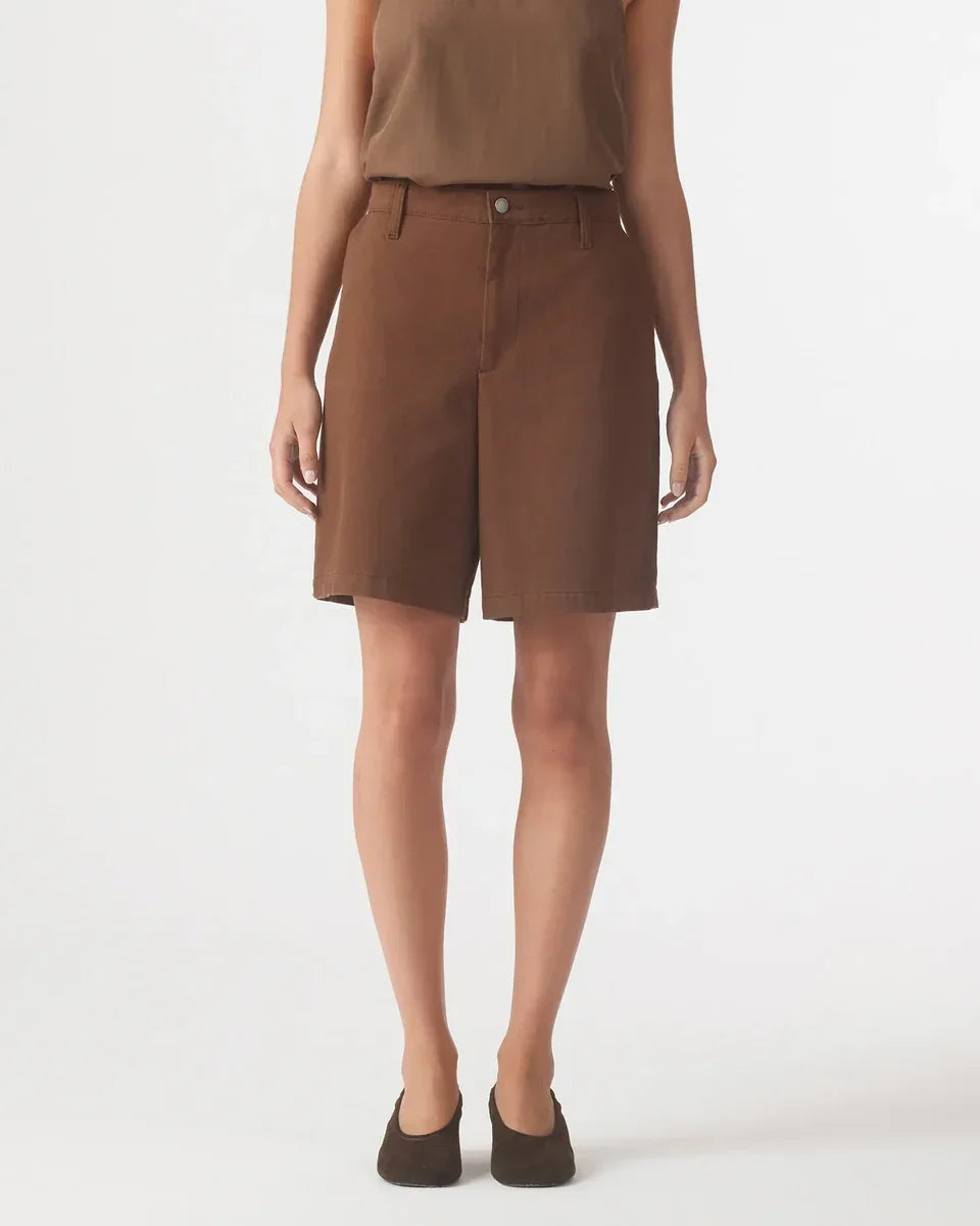 Woman wearing Nobody Denim Rowan Bermuda Shorts in coffee brown with brown shoes.