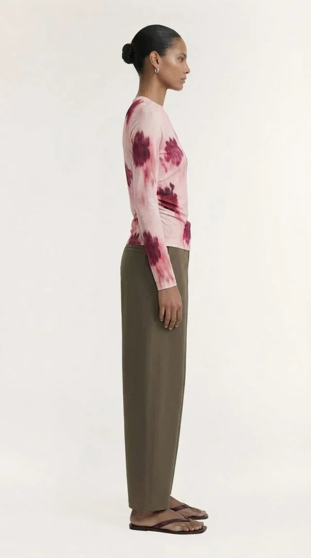 Woman in a pink tie-dye long sleeve top and olive green maxi skirt