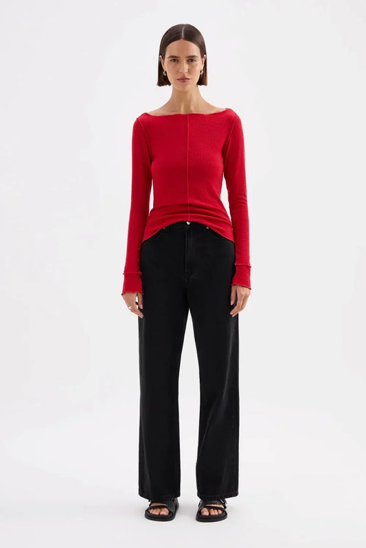 Red off-shoulder top with black wide-leg jeans and sandals