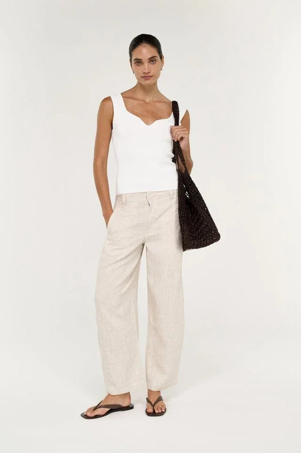 Woman wearing STAPLE THE LABEL Neve Linen Barrel Leg Pants in beige with a white top