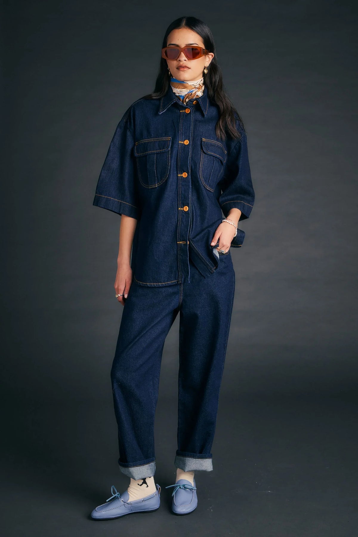 Woman wearing Outland Denim X Karen Walker Mod Shirt and matching indigo jeans.
