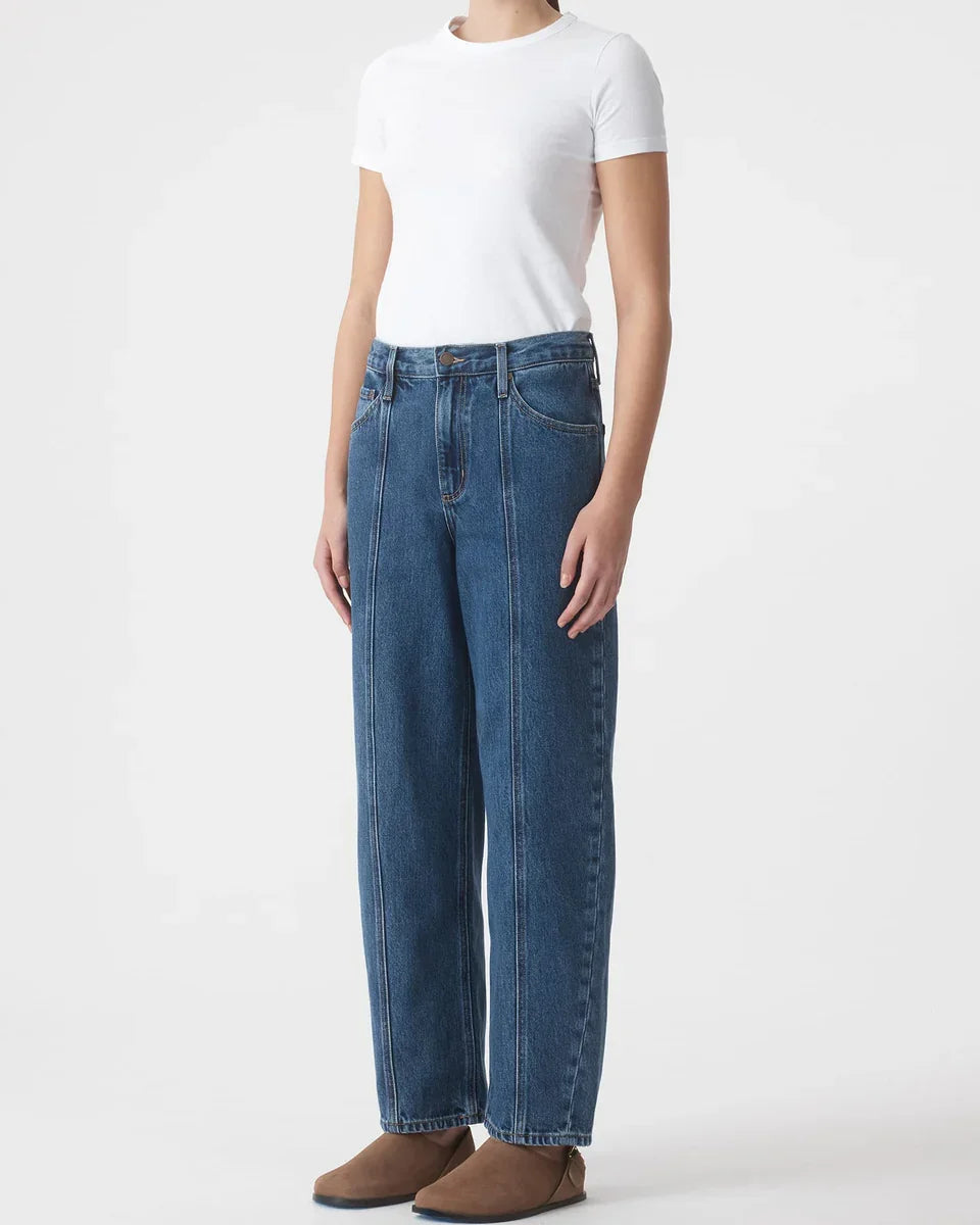 Woman wearing high-waisted wide-leg jeans with white t-shirt and brown boots