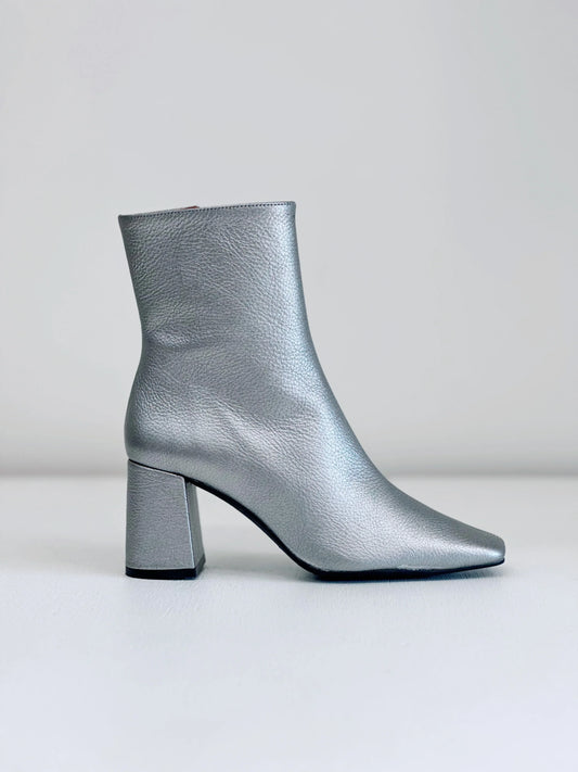 Silver leather ankle boot with block heel and pointed toe on white background