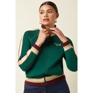 Woman wearing a green zip-up bomber jacket with cream and burgundy trim, stylish casual fashion