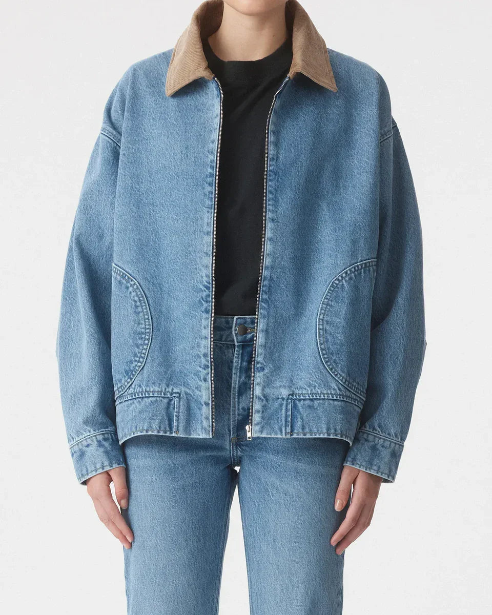 Woman wearing a blue denim jacket with brown corduroy collar and matching jeans